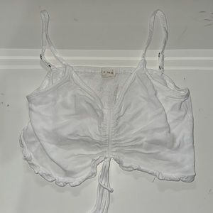 Cute white tank top. Brand L.A. Hearts. Size Medium but sizes run very small!